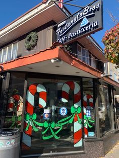 a store front with candy canes painted on it