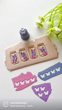 three different shaped magnets sitting on top of a white table next to some flowers