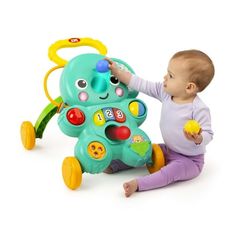 a baby is playing with a toy on the white background, it looks like he's learning