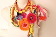 "Orange Hippie necklace, Colorful Crochet Scarf, Textile art pendant, Flowers Boho Scarf, Unique Scarf, Orange Flower, Women Hallowen gift Pink flowers, handmade leaves. It's an improvised work. It is made of recycled fabrics. I love this kind of job. Yours. The scarf is handmade. Leaves and handmade like crochet and flower cycle. chiffon fabric ornament. Unique product. I can easily tell you the gift options. My shop is not a repeat of crochet knit products. you will only be when you buy it. It Multicolor Necklaces With Handmade Flowers For Gift, Orange Bohemian Flower Necklace, Bohemian Orange Flower Necklace, Whimsical Multicolor Flower Necklace, Unique Multicolor Flower Necklaces, Unique Multicolor Flower Necklace, Flower Cycle, Fabric Ornament, Unique Scarf