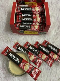 several packets of nestle are next to a bowl of coffee