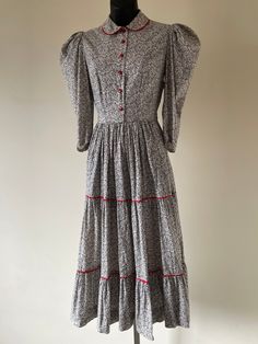 "Antique 1930s Black & White Floral Prairie Dress. Peter Pan collar. Puffed 3/4 length sleeves. Cherry red buttons & ric-rac trim. Original metal 'Conmar' zipper at side of garment. Measurements: Bust: 34\" Waist: 28\" Hips: Open Length: 46\" Condition: Excellent, vintage condition." Fitted Long Sleeve Prairie Dress With Buttons, Velvet Circle Skirt, Dress Peter Pan Collar, 1910s Fashion, Printed Cotton Dress, Ric Rac, Black Velvet Dress, Dreamy Dress, Prairie Dress