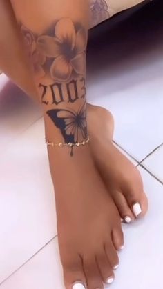 a woman's foot with tattoos on it