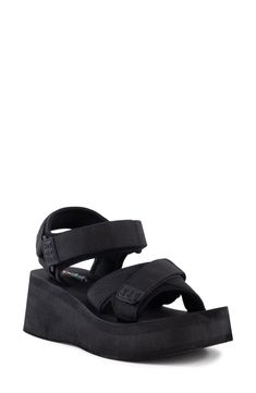 Channel sporty, modern style in this monochrome sandal set on a lofty platform sole. 2 1/4" heel; 1 1/2" platform Adjustable ankle strap with hook-and-loop closure Textile upper and lining/synthetic sole Imported Black Sport Sandals With Platform And Double Strap, Black Double Strap Platform Sport Sandals, Platform Sandals With Cross Strap, Synthetic, Black Platform Slip-on Footbed Sandals, Outdoor Platform Sandals, Synthetic Material, Platform Wedge, Platform Wedge Sandals, Wedge Sandal, Sandal Women