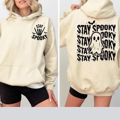 Stay Spooky Sweatshirt, Halloween Sweatshirt, Halloween Gifts Hoodie, Womens Halloween Sweatshirt, Spooky Season Sweatshirt, Ghost Halloween Hello! Welcome to Cstm Tshrt Designs, Discover our premium personalized t-shirts crafted from luxurious materials that provide a delightful feel against your skin. Choose from a diverse array of colors and designs to find a shirt that perfectly aligns with your unique personality and style preferences. Whether you seek a humorous graphic tee, a bold stateme Trendy Graphic Print Halloween Hoodie, Halloween Streetwear Sweatshirt With Letter Print, Halloween Letter Print Sweatshirt For Streetwear, Trendy White Halloween Hoodie, Trendy Halloween Hoodie Sweatshirt, Fall Hooded Graphic Print T-shirt, Hooded Graphic Print T-shirt For Fall, Halloween Hoodie Sweatshirt With Graphic Print, Halloween Graphic Print Hoodie Sweatshirt