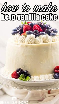 a white cake with berries and blueberries on top is sitting on a plate that says how to make keto vanilla cake