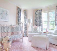 a baby's room with pink carpet and white furniture