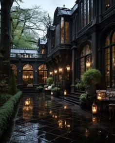 an outdoor courtyard with tables and chairs lit up at night