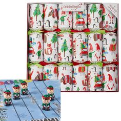 christmas wrapping rolls with elfs on them in a cardboard box and an image of santa's helpers