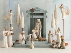 a nativity scene with figurines and trees