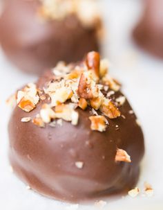 chocolate covered donuts with nuts and pecans on top