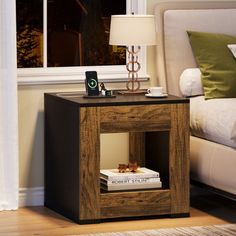 a night stand with books and a phone on it