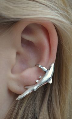 This is one of our original designs from 35 years agol Our very detailed Ear Cuff "The Shark". If you love Sharks, you will LOVE this Ear Cuff.  It is very intriguing and will make a bold statement on your ear!  This Ear Cuff is non pierced and hugs your ear comfortably and securely. It is made of solid Sterling Silver, and adjusts to fit either ear.  This piece will arrive in a Gift Box and include simple fitting instructions. Perfect for gift giving Greek Outfit, Weird Clothes, Shark Stuff, Pretty Piercings, Shark Jewelry, Shark Pictures, 2024 Wishlist, Shark Earrings, Quirky Jewelry