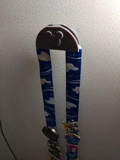 a pair of blue toothbrushes sitting on top of each other in front of a white wall