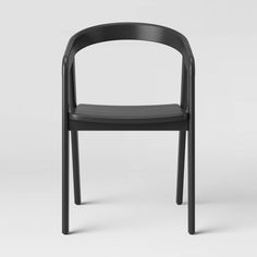 a black plastic chair sitting on top of a white floor