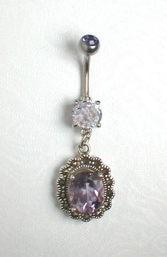 an image of a belly piercing with a purple stone