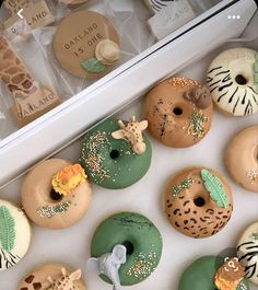 an assortment of decorated doughnuts in a box