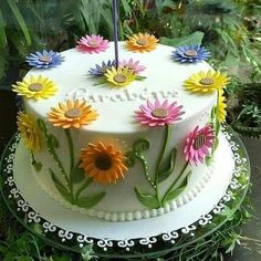 a cake decorated with flowers and the words garden on it