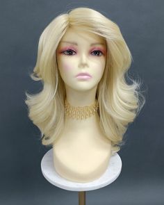 "Synthetic wig featuring thick, slightly texturized (for volume) heat-safe fibers along with a partial skin top. Mostly straight with glamorous loose waves. Inside cap has adjustable elastic straps, no combs or clips. Heat-resistant at 350F. Color: Light Blonde (613) Length: 18 Inches Circumference: 21\" with adjustable cap (max 22\") Materials: Heat Resistant Synthetic Wig Fiber All sales are final. Please read all store policies before purchasing." Curly Iron, Crystal Hair Band, Puffy Hair, Caramel Blonde, Bob Lace Front Wigs, Star Headband, Blonde Bombshell, Blonde Wig, Light Blonde