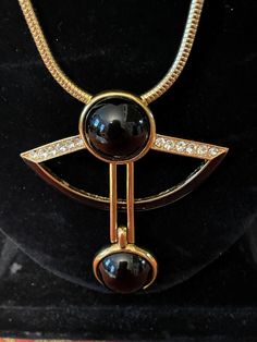 89 Jean Fouquet art deco necklace. Vintage Art Deco 89 Pendant Necklace of Jean Fouquet Design Signed. Blue Glass Stone Highly collectible ART DECO/89 necklace with two black stone attached on gold tone bar, black enamel half moon on the bottom and rhinestones on top of the  pendant. snake chain with fold over closer. exceptional necklace by Jean Fouquet, the master of Parisian jewelry in the 1920s,  Marked  ©ART DECO/89 TM with the model number B012  on the back. Boutique costume jewelry at its best. In good vintage condition . Measurements about. Chain length  27" pendant length 2.75  width 2.5  Etsy Shipping Please read -Vintage and pre-owned items may have signs of wear and use and are offered as is. Traces of age and use are therefore completely normal and do not constitute defects. P Art Deco Pendant Necklace For Formal Occasions, Luxury Black Metal Necklace, Formal Black Enamel Pendant Necklace, Formal Black Enamel Round Necklaces, Formal Art Deco Round Necklace, Formal Round Black Enamel Necklaces, Elegant Black Enamel Necklaces For Evening, Elegant Evening Black Enamel Necklaces, Elegant Evening Necklaces With Black Enamel