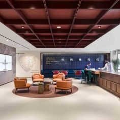 an office lobby with two people sitting at the counter