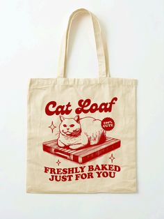 a tote bag with an image of a cat sitting on top of a book