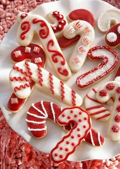 decorated cookies are arranged on a plate with red and white ribbons in the shape of numbers