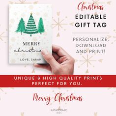 a hand holding up a christmas card with the words merry christmas and pine trees on it