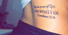 a woman with a tattoo on her back saying be the grace of god, i am what i am