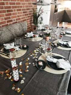 the table is set with plates and silverware for an elegant dinner or special event