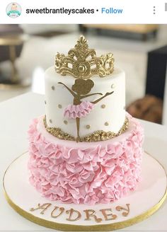 a three tiered cake decorated with pink and gold ruffles on top of a white table