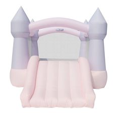 the inflatable bouncer is pink and has two large turrets on top of it