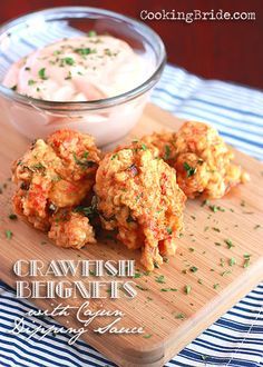 some food is sitting on a cutting board next to a bowl of ranch dips