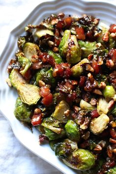 brussel sprouts with cranberries and nuts in a white bowl