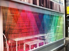 an image of a colorful window display in the storefronts with chairs and tables