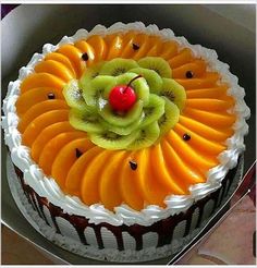 there is a cake in the box with fruit on top