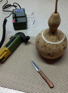 a potato sitting on top of a table next to a knife and some other items