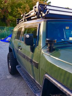 a green truck parked in a parking lot