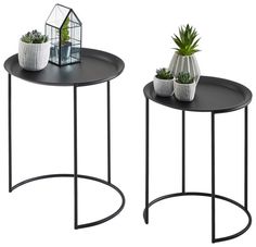 two black tables with plants on them