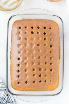 a glass baking dish filled with batter and chocolate chips on top of a white table