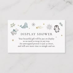 a white business card with an image of penguins and snowflakes in the background