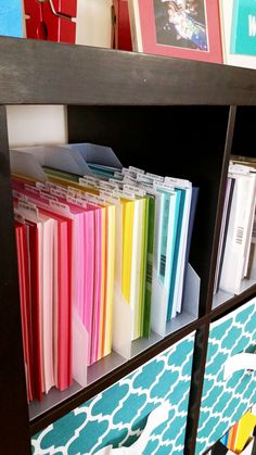 a book shelf filled with binders and folders on top of eachother