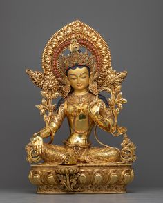 a golden buddha statue sitting on top of a table