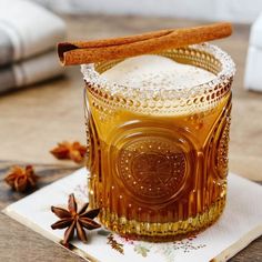 a glass jar filled with liquid and cinnamon sticks