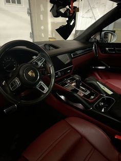 the interior of a car with red leather seats and steering wheel, dash board, and dashboard