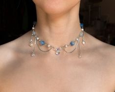 This handmade beaded Blue Fairy Necklace is made with glass, acrylic, and resin beads, with stainless steel chains.  ✧ Size: 12 inches with a 2-inch extender (adjustable to 14 inches). Perfect for those with a petite neck. If you need a larger or smaller size, message me with your desired measurements! I can add more beads and/or a second extender.  ✧ Closure: Lobster claw ✧ Care: For longevity, please keep away from water and perfumes. If you have any questions, feel free to reach out ♡ For more, visit my shop: https://www.etsy.com/shop/stardropstop Fairy Beaded Necklace, Necklace Fairycore, Homemade Necklaces, Cottagecore Jewelry, Fairycore Cottagecore, Y2k Necklace, Diy Necklaces, Handmade Chokers, Princess Core