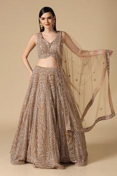 Gold can can attached lehenga skirt featuring floral motifs in shimmer thread embroidery, highlighted with mirrorwork embellishments. Comes with padded thread embroidered blouse and dupatta. - Aza Fashions Diwali Embellished Net Lehenga, Embellished Net Lehenga For Diwali, Embellished Semi-stitched Net Choli, Designer Embellished Net Lehenga, Embellished Net Lehenga For Festive Occasions, Festive Embellished Net Lehenga, Net Choli With Mirror Work For Reception, Sleeveless Embellished Organza Lehenga, Embellished Lehenga For Navratri