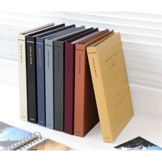 a stack of books sitting on top of a white counter