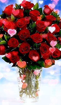 a vase filled with red roses on top of a table