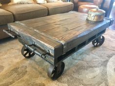 a coffee table made out of an old wooden pallet with wheels on the bottom